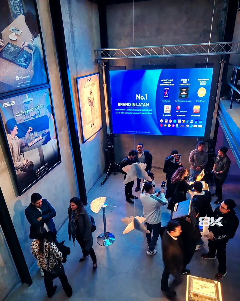 Asistentes en un evento de marca en un showroom con pantalla LED en truss